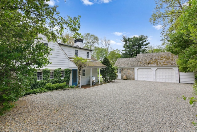 167 Skunk Ln, Wilton, CT 06897 - view of front of house with an outbuilding, a detached garage, and a chimney