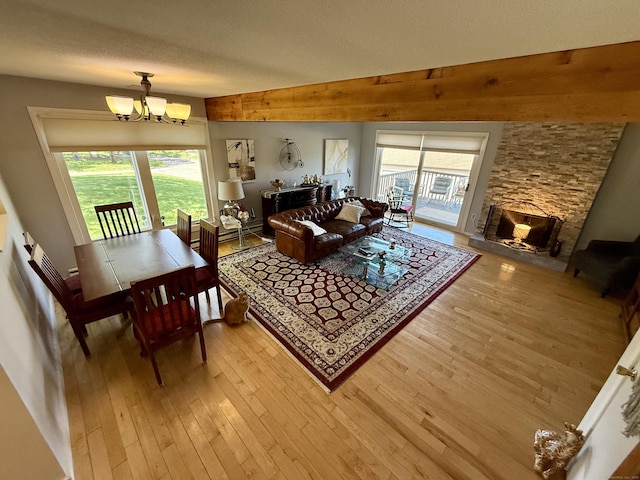 15 Pilgrim Hbr Unit A, Wallingford, CT 06492 - living room featuring a chandelier, light wood-type flooring, a textured ceiling, and a fireplace