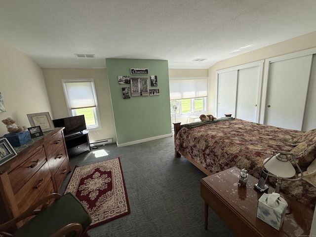 15 Pilgrim Hbr Unit A, Wallingford, CT 06492 - bedroom with a baseboard heating unit, multiple windows, dark carpet, two closets, and a textured ceiling