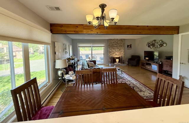 15 Pilgrim Hbr Unit A, Wallingford, CT 06492 - dining room with wood finished floors, a chandelier, beam ceiling, and a baseboard heating unit