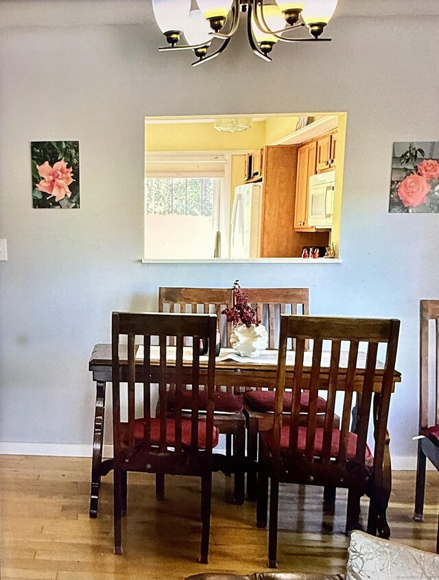 15 Pilgrim Hbr Unit A, Wallingford, CT 06492 - dining space with wood finished floors, baseboards, and a chandelier