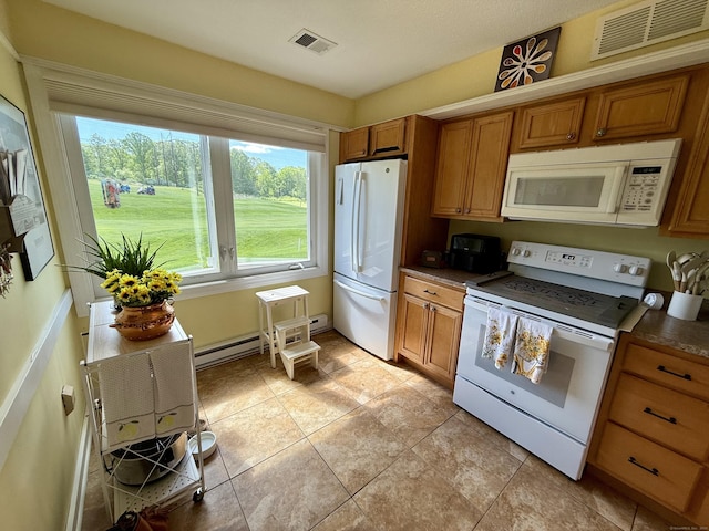 15 Pilgrim Hbr Unit A, Wallingford, CT 06492 - kitchen featuring white appliances, brown cabinets, a baseboard heating unit, light tile patterned floors, and dark countertops