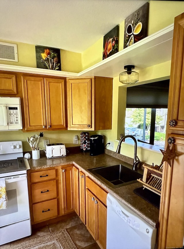 15 Pilgrim Hbr Unit A, Wallingford, CT 06492 - kitchen with white appliances, a sink, brown cabinetry, and dark countertops