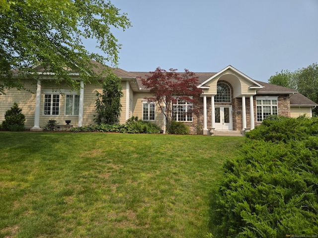 21 Autumn Cir, Rocky Hill, CT 06067 - view of front facade featuring french doors, a front lawn, and stone siding