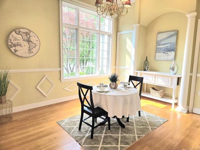 21 Autumn Cir, Rocky Hill, CT 06067 - dining room featuring ornate columns, a chandelier, and wood finished floors