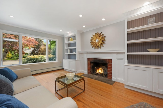 living room featuring a baseboard radiator, light wood finished floors, ornamental molding, a fireplace, and recessed lighting