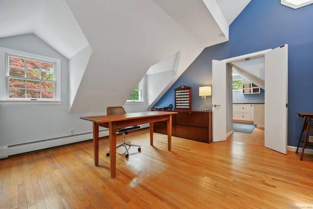 office featuring light wood-style floors, lofted ceiling, and baseboards