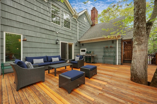wooden deck featuring an outdoor living space and a grill
