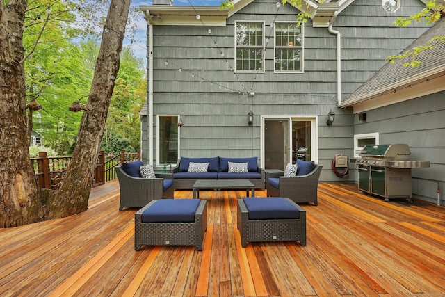 wooden terrace with outdoor lounge area and grilling area