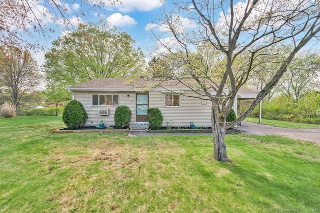 view of front of property with driveway, a shingled roof, and a front yard
