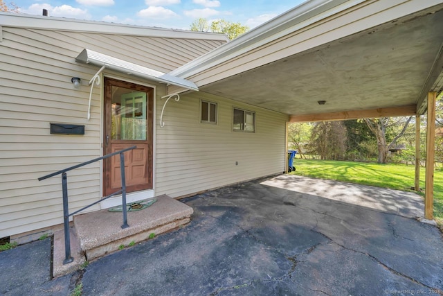 view of patio / terrace featuring a carport and aphalt driveway