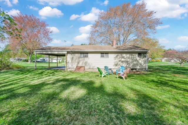 rear view of house with a yard and a chimney