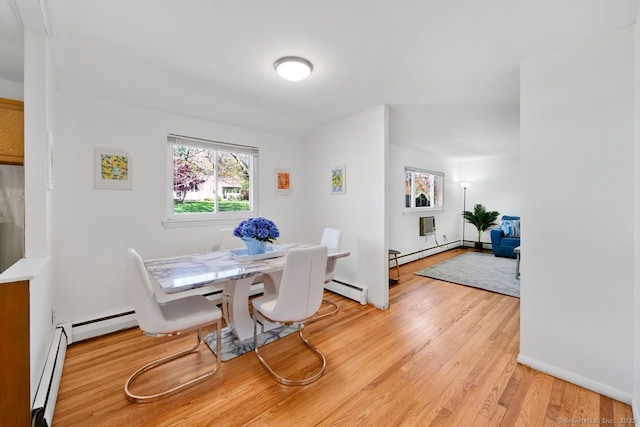 dining space with light wood-style floors and baseboard heating