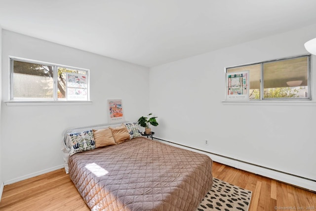 bedroom featuring baseboards and wood finished floors