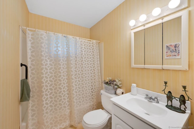 bathroom with toilet, wallpapered walls, shower / tub combo with curtain, and vanity