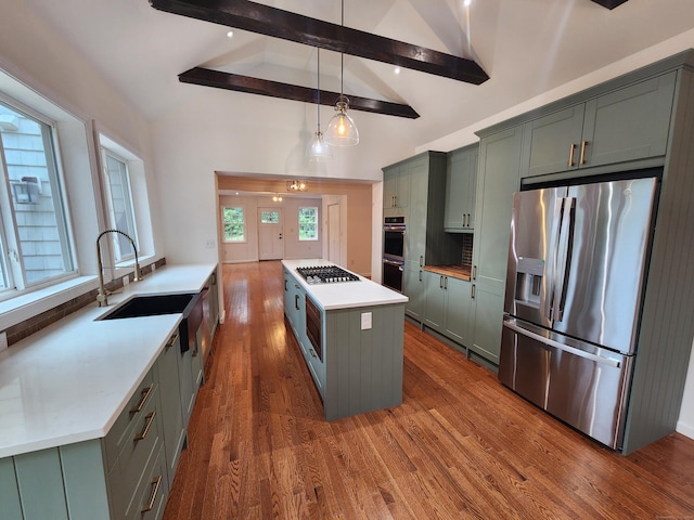 154 Falls Rd, East Haddam, CT 06469 - kitchen featuring stainless steel appliances, green cabinets, beam ceiling, dark wood-style flooring, and a center island