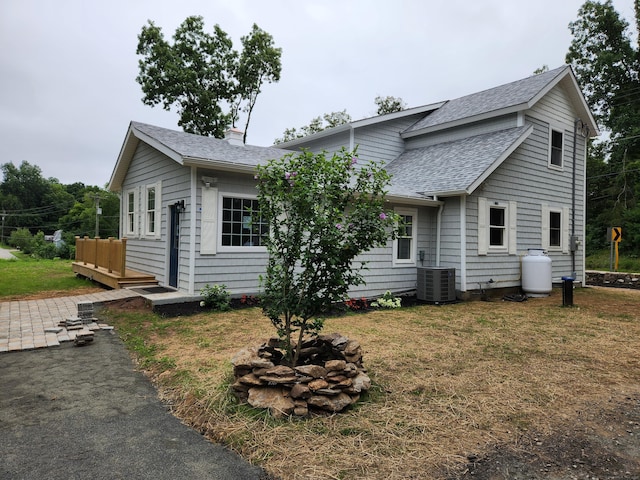 154 Falls Rd, East Haddam, CT 06469 - view of front of home with a shingled roof, a front yard, a chimney, and a deck