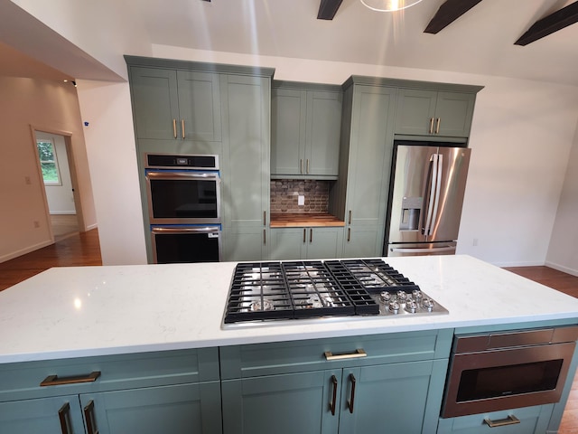 154 Falls Rd, East Haddam, CT 06469 - kitchen featuring stainless steel appliances, tasteful backsplash, dark wood-type flooring, and light stone countertops