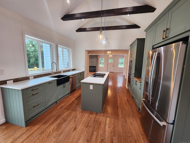 154 Falls Rd, East Haddam, CT 06469 - kitchen with appliances with stainless steel finishes, a center island, dark wood-style floors, and light countertops