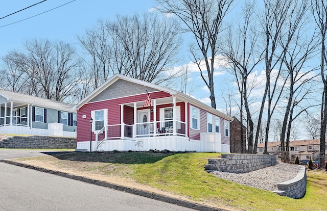 view of front of home with a porch and a front lawn