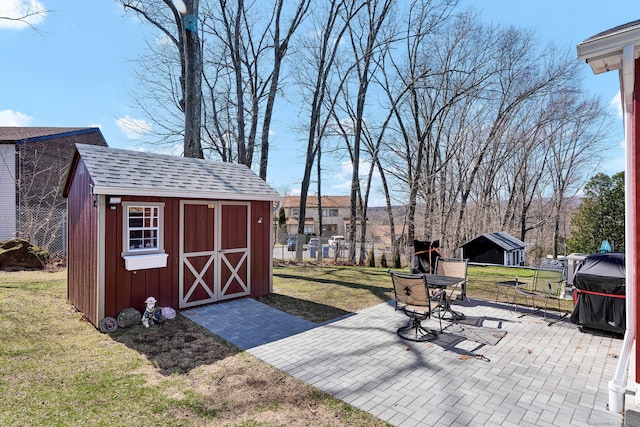 view of patio featuring fence, an outbuilding, and a storage shed