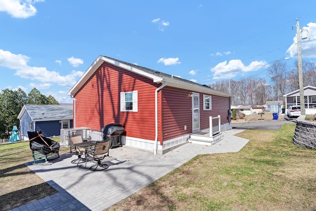 rear view of house with a yard and a patio area