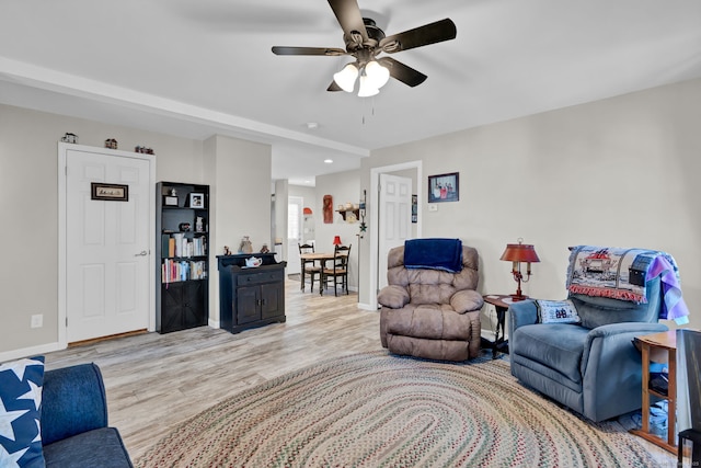 living area with baseboards, recessed lighting, wood finished floors, and a ceiling fan