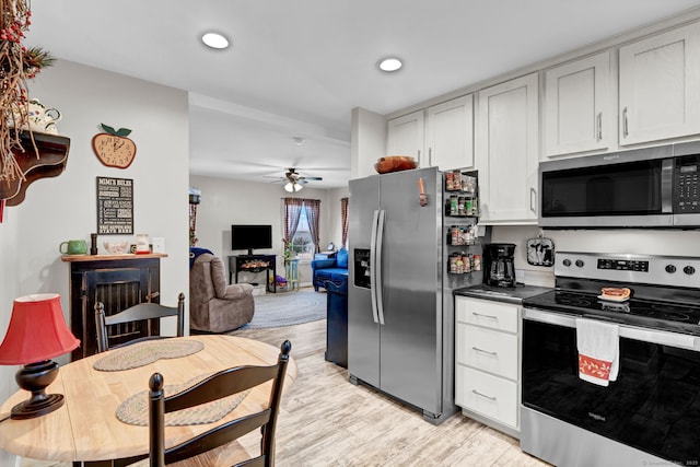 kitchen with white cabinetry, light wood-style floors, stainless steel appliances, recessed lighting, and a ceiling fan