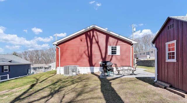 back of property with a patio, fence, central AC unit, and a lawn
