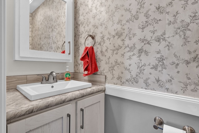 bathroom featuring wallpapered walls and vanity