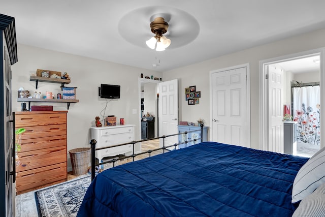 bedroom featuring ceiling fan and ensuite bath