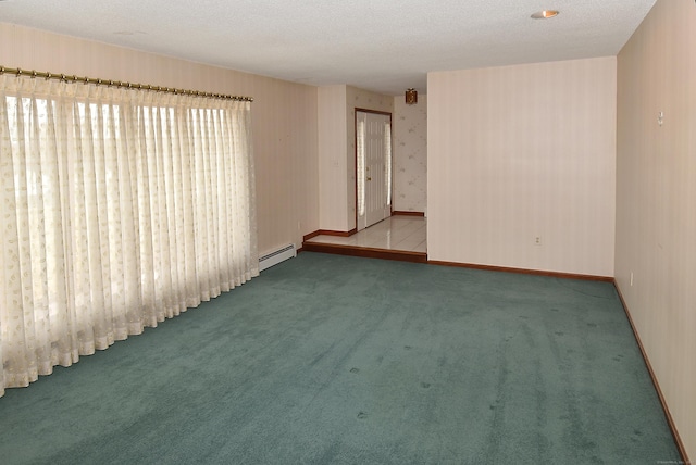 empty room with baseboard heating, baseboards, wallpapered walls, a textured ceiling, and carpet