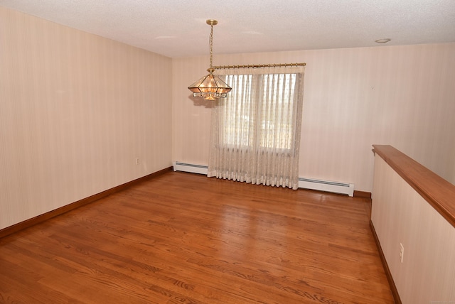 unfurnished room with baseboards, a baseboard radiator, a chandelier, a textured ceiling, and wood finished floors