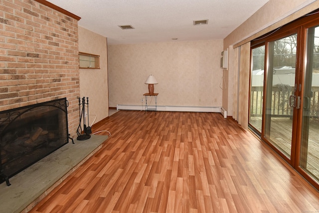 unfurnished living room featuring light wood-style flooring, a baseboard radiator, and a brick fireplace