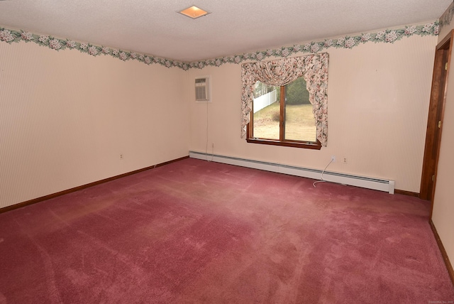 unfurnished room with a textured ceiling, baseboard heating, a wall mounted AC, carpet flooring, and baseboards