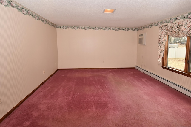 spare room with baseboards, carpet, a baseboard heating unit, and a textured ceiling