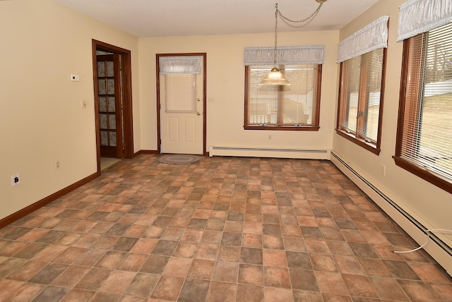 empty room with baseboard heating and baseboards