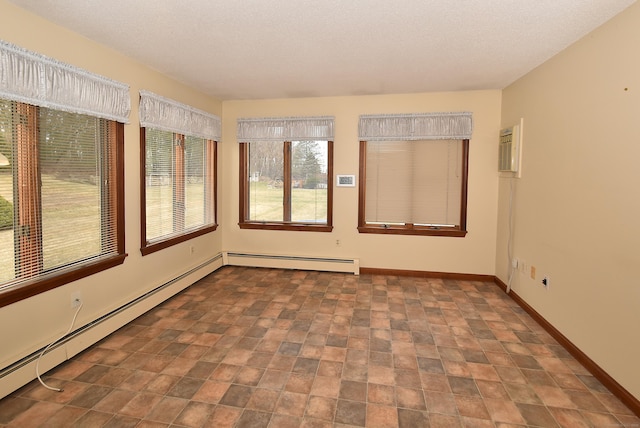 unfurnished sunroom with a baseboard radiator, baseboards, and a textured ceiling