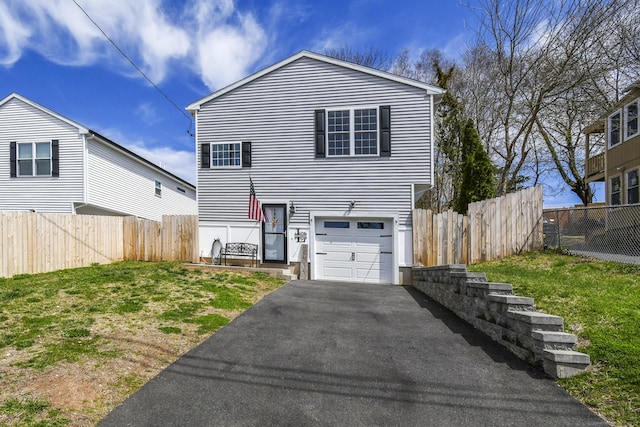 10 Bidwell Ter, Middletown, CT 06457 - view of front of home with fence, aphalt driveway, and a garage