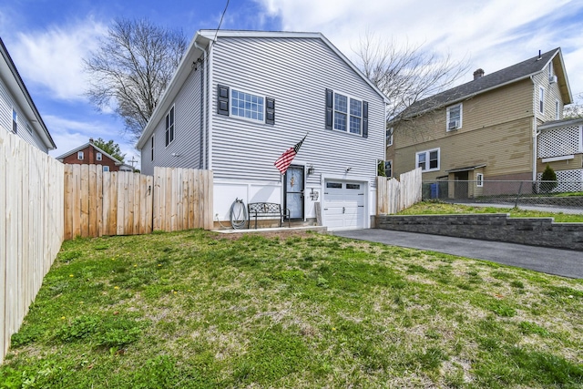 10 Bidwell Ter, Middletown, CT 06457 - view of front of home with an attached garage, a front yard, fence, and driveway