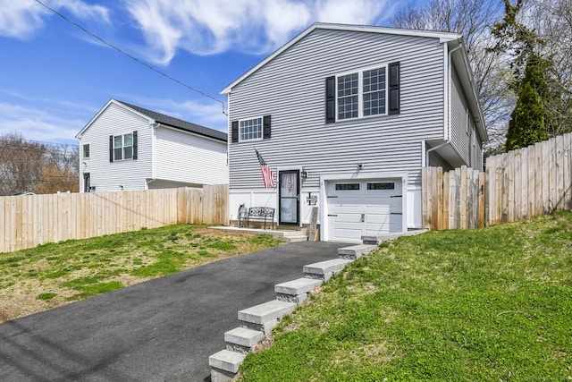 10 Bidwell Ter, Middletown, CT 06457 - view of front facade with an attached garage, a front lawn, fence, and driveway