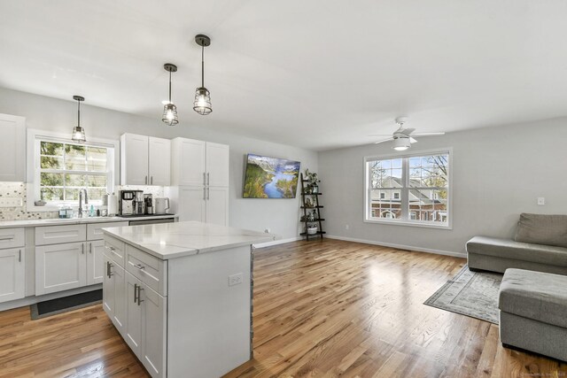 10 Bidwell Ter, Middletown, CT 06457 - kitchen with a ceiling fan, a sink, a center island, light wood-style flooring, and open floor plan