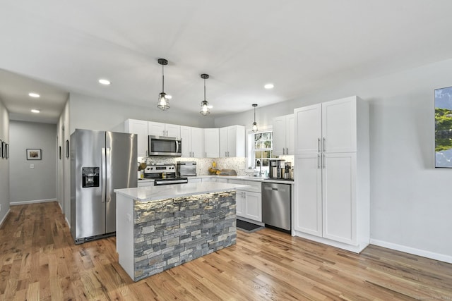 10 Bidwell Ter, Middletown, CT 06457 - kitchen with a sink, light wood-style floors, white cabinetry, light countertops, and appliances with stainless steel finishes