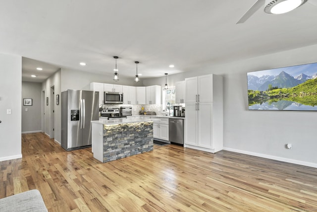 10 Bidwell Ter, Middletown, CT 06457 - kitchen featuring light wood finished floors, stainless steel appliances, baseboards, white cabinetry, and light countertops