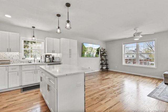 10 Bidwell Ter, Middletown, CT 06457 - kitchen with a sink, light wood-style flooring, tasteful backsplash, open floor plan, and ceiling fan