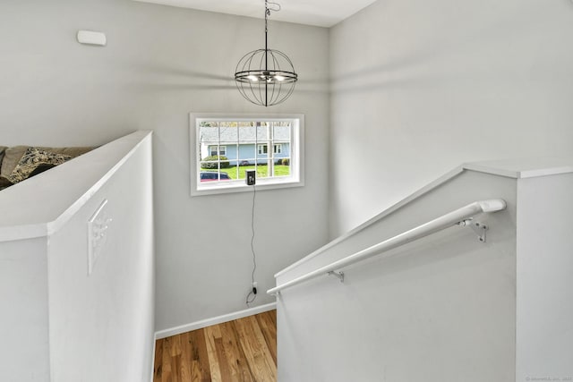 10 Bidwell Ter, Middletown, CT 06457 - staircase featuring baseboards, wood finished floors, and an inviting chandelier