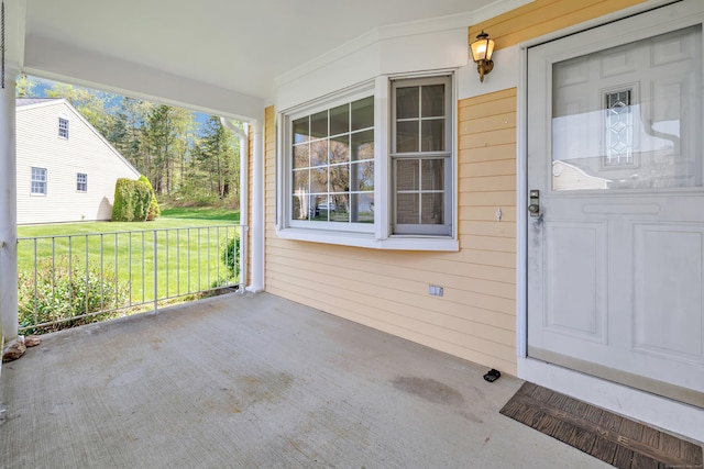 doorway to property featuring a yard and a porch