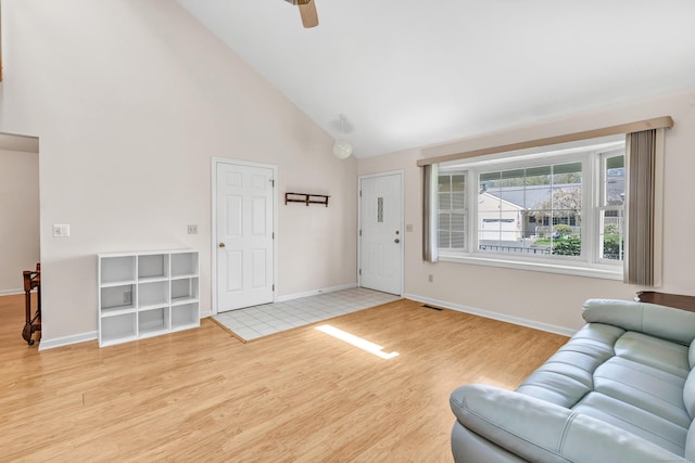 living area with wood finished floors, a ceiling fan, high vaulted ceiling, visible vents, and baseboards