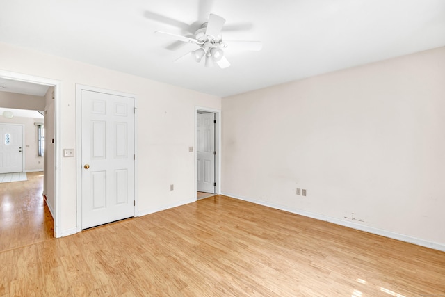unfurnished bedroom featuring light wood-style flooring, baseboards, and ceiling fan