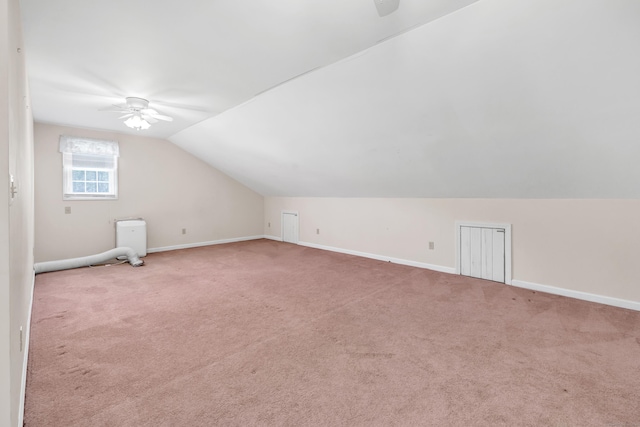 bonus room with ceiling fan, lofted ceiling, carpet flooring, and baseboards